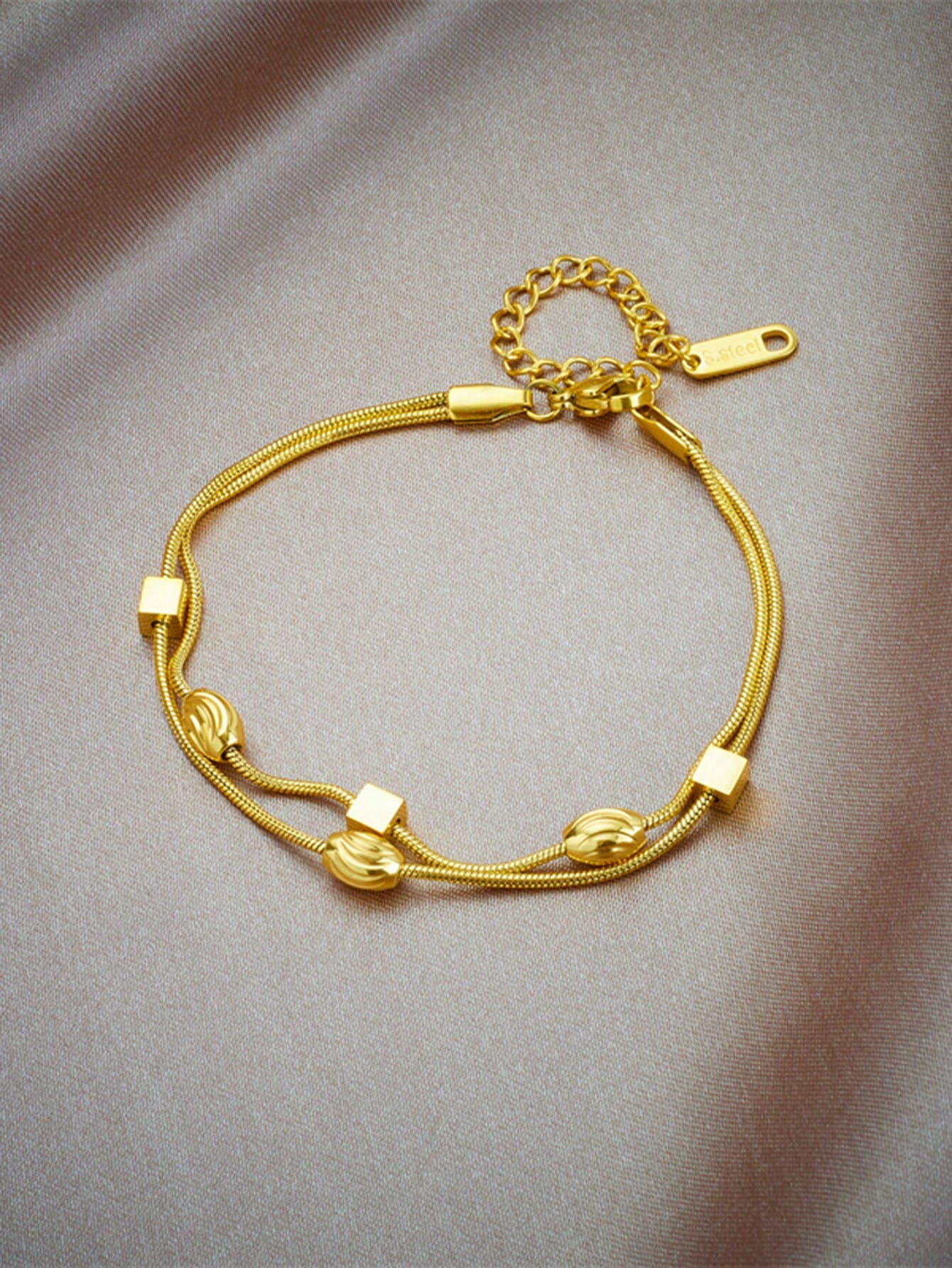 Double layer woven studded chain bracelet in gold plated stainless steel with screw-in fastening