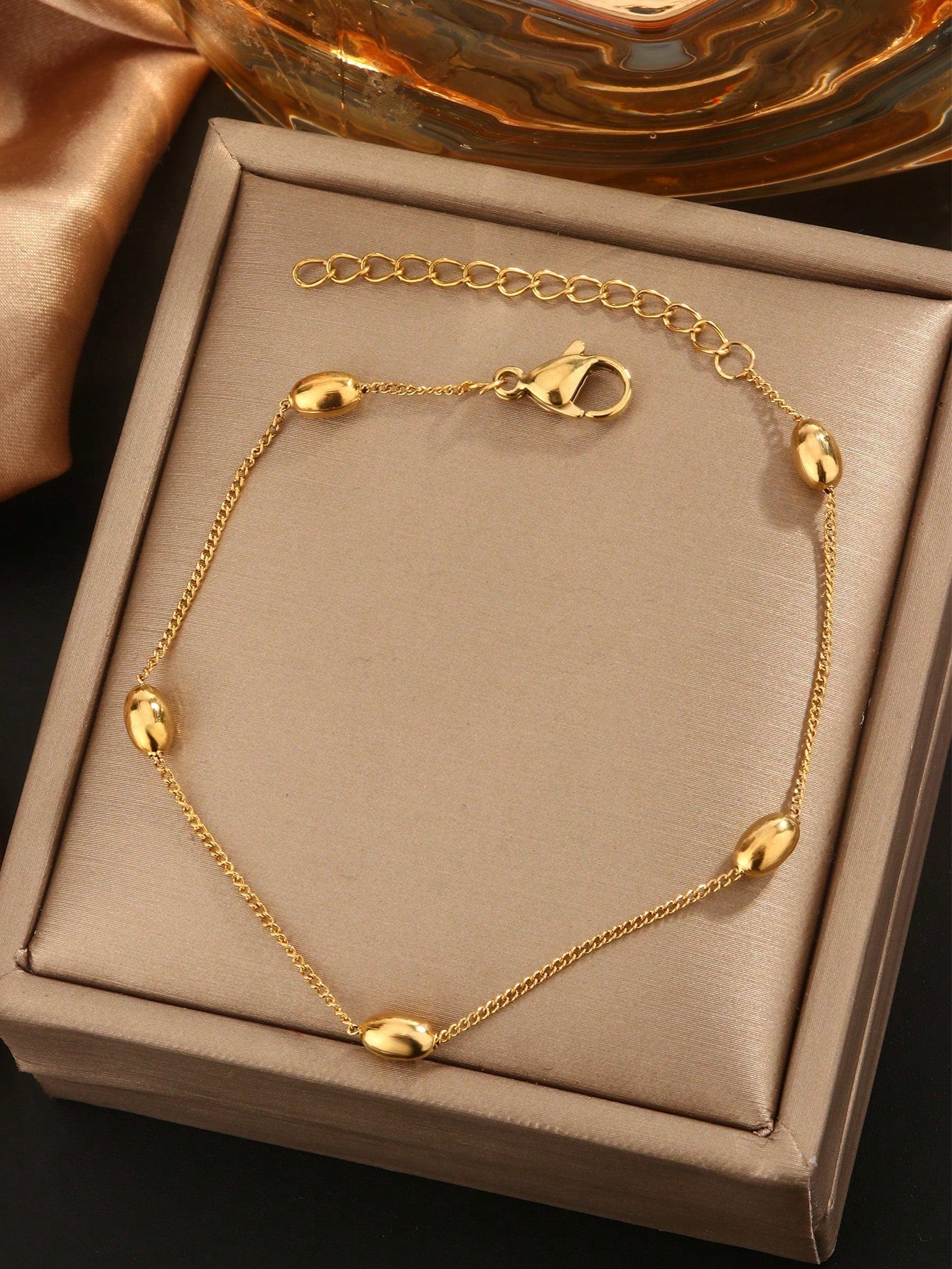 Fashionable and elegant 18k gold plated stainless steel bracelet with multiple oval beads, suitable for women to wear at gatherings or as a gift for mothers.