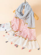 Geometric pattern shawl with brooch-embellished hem