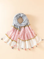 Geometric pattern shawl with brooch-embellished hem