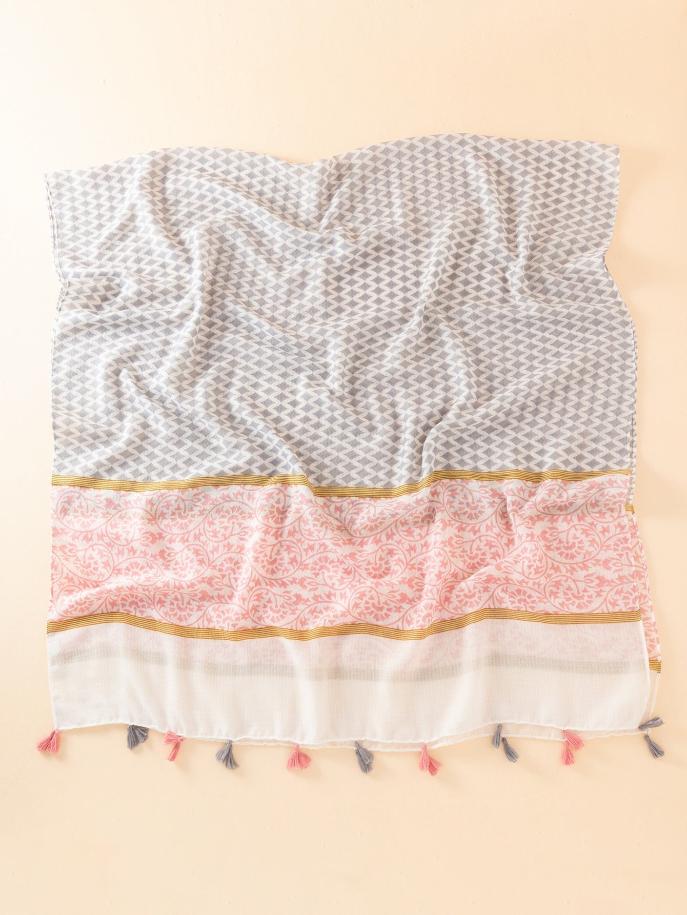 Geometric pattern shawl with brooch-embellished hem