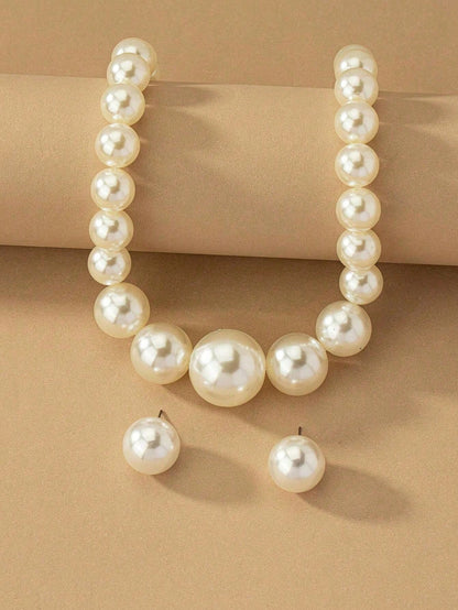 Faux pearl earrings and faux pearl necklace are exaggerated and trendy at the same time