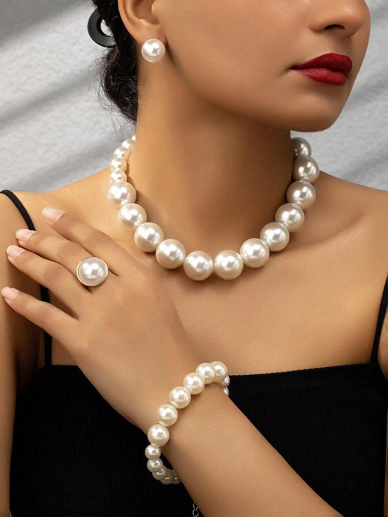 Faux pearl earrings and faux pearl necklace are exaggerated and trendy at the same time