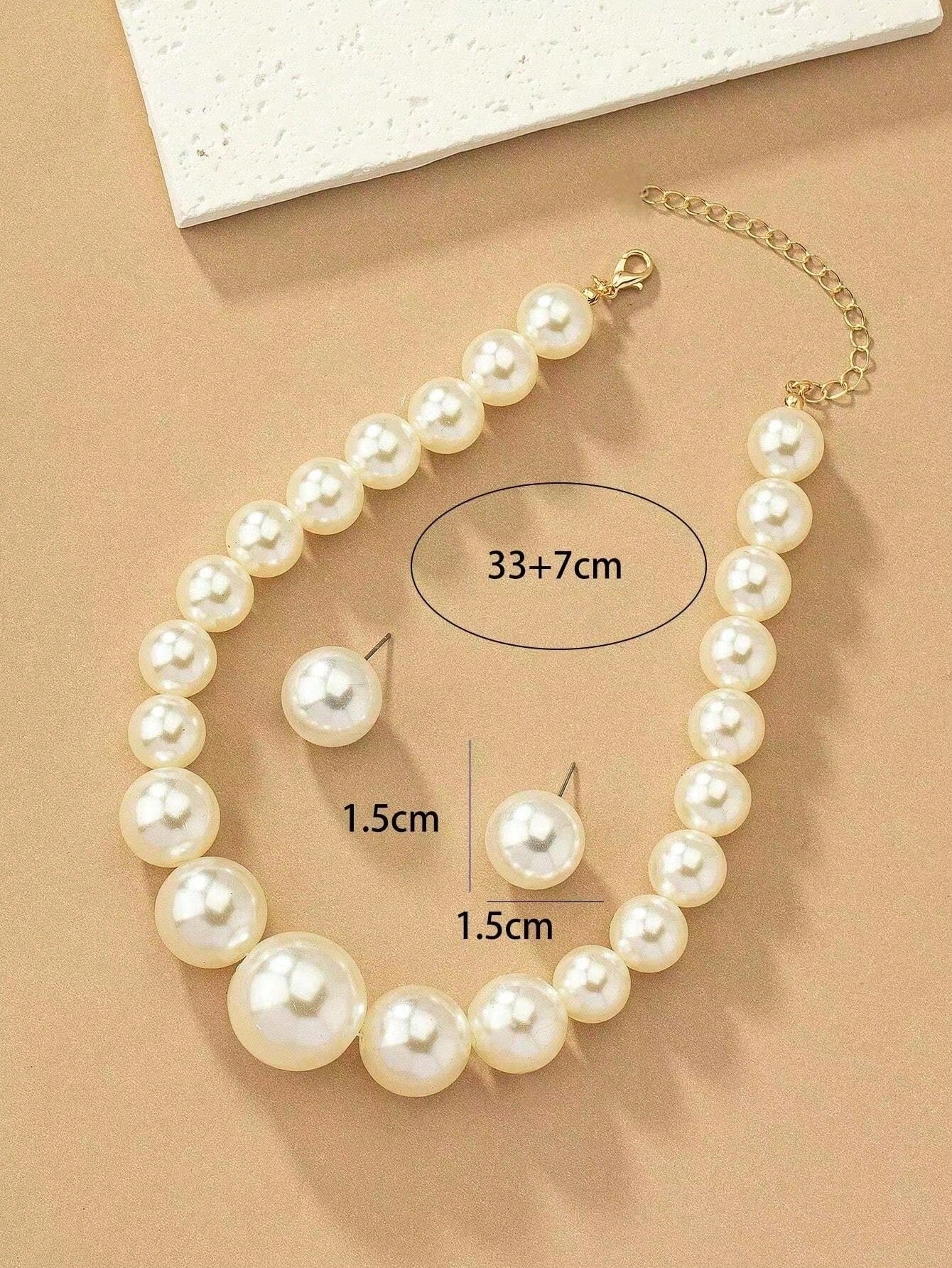 Faux pearl earrings and faux pearl necklace are exaggerated and trendy at the same time