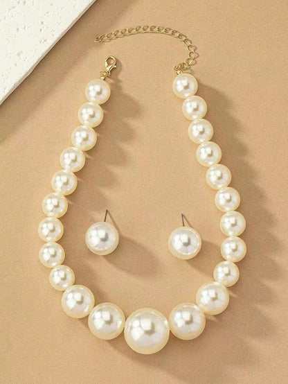 Faux pearl earrings and faux pearl necklace are exaggerated and trendy at the same time