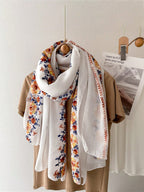 A summer botanical print scarf that is sun-resistant and perfect for desert trips. A delicate beach scarf for women.